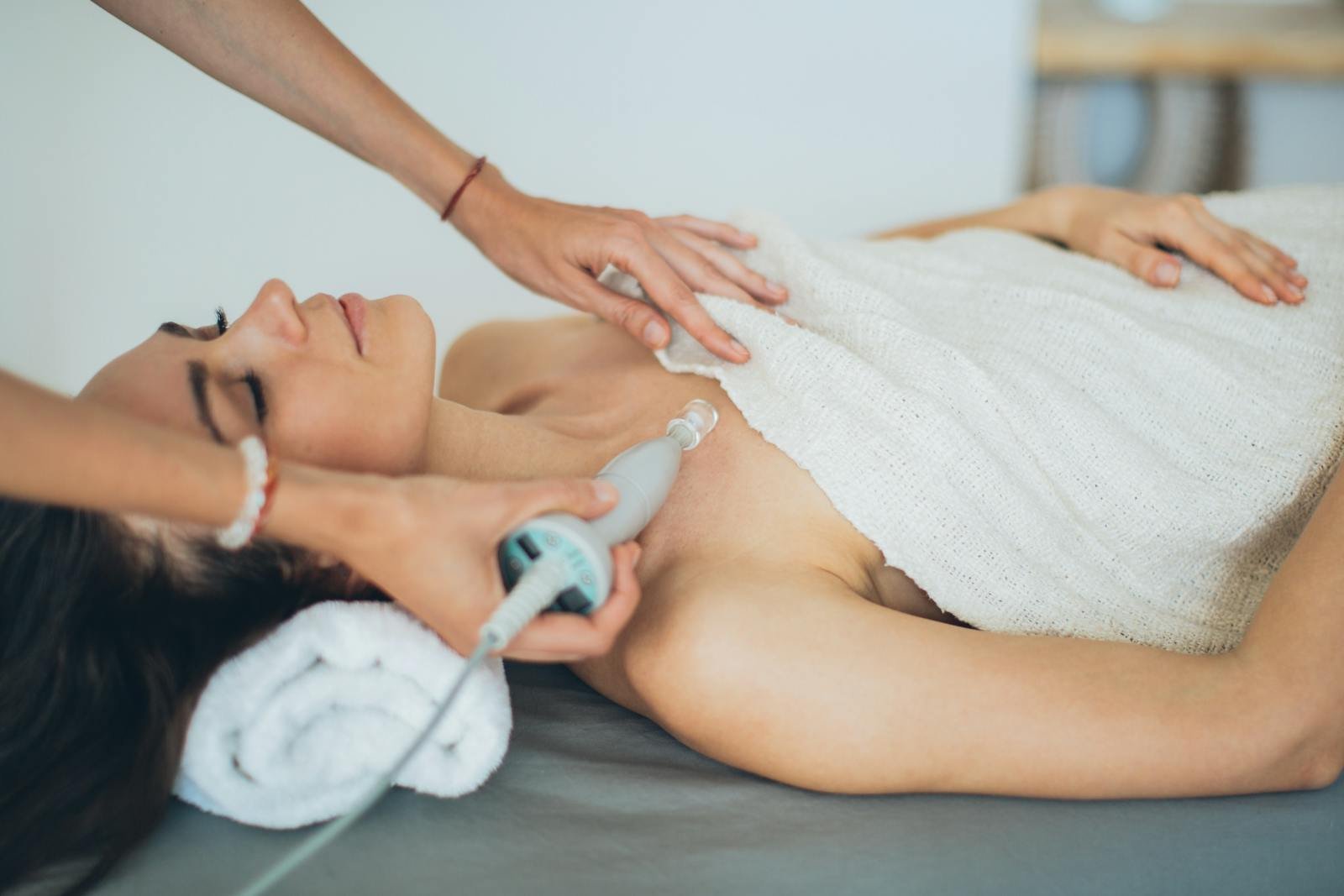 Woman receiving a laser spa treatment focused on relaxation and wellness.